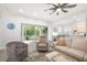 Bright living room featuring access to the outdoor patio and eat-in kitchen at 7016 Lennox Pl, University Park, FL 34201