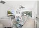 Bright and airy living room with sliding glass doors opening to an outdoor patio, combining indoor and outdoor living at 7016 Lennox Pl, University Park, FL 34201