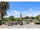 Relaxing outdoor patio with comfortable seating overlooking a picturesque golf course and lake at 7016 Lennox Pl, University Park, FL 34201