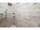 Modern walk-in shower featuring stylish tiles, multiple shower heads and convenient shelving makes this shower luxurious at 7016 Lennox Pl, University Park, FL 34201