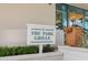 The Park Grille sign with manicured shrubbery and a glimpse of the building's design at 7016 Lennox Pl, University Park, FL 34201