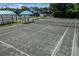 Community tennis court featuring shaded seating area and well-maintained surface for active recreation at 7016 Lennox Pl, University Park, FL 34201