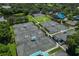 Community tennis courts surrounded by lush trees and pristine lake at 7016 Lennox Pl, University Park, FL 34201
