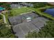 Aerial view of community tennis courts and lush green landscaping at 7016 Lennox Pl, University Park, FL 34201