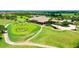 Aerial view of a golf course clubhouse and perfectly manicured green at 7158 Westhill Ct, Lakewood Ranch, FL 34202