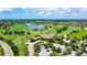 Aerial view of beautiful golf course, lake, clubhouse, and homes in the community at 7158 Westhill Ct, Lakewood Ranch, FL 34202