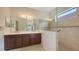 Bathroom with dual sinks, wood cabinetry, and glass shower doors at 7158 Westhill Ct, Lakewood Ranch, FL 34202