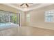 Bedroom featuring tiled flooring, a ceiling fan, and access to a screened-in outdoor pool area at 7158 Westhill Ct, Lakewood Ranch, FL 34202