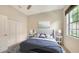 Cozy bedroom featuring a plush bed, bedside lamps, and bright natural light from a nearby window at 7158 Westhill Ct, Lakewood Ranch, FL 34202