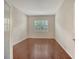 This bedroom features beautiful wood floors, a light-filled window with shutters, and neutral wall color at 7158 Westhill Ct, Lakewood Ranch, FL 34202