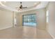 Bedroom with tiled flooring, ceiling fan, and access to a screened-in outdoor pool area at 7158 Westhill Ct, Lakewood Ranch, FL 34202