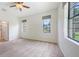 Bedroom with neutral carpet, ceiling fan, and lots of natural light from multiple windows at 7158 Westhill Ct, Lakewood Ranch, FL 34202