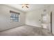 Bedroom with carpet, a large window, and an ensuite bathroom at 7158 Westhill Ct, Lakewood Ranch, FL 34202
