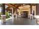 Club entrance with stone columns and accents, covered entrance, and tile flooring at 7158 Westhill Ct, Lakewood Ranch, FL 34202