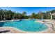 Large community pool featuring clear blue water, lounge chairs, and tropical landscaping at 7158 Westhill Ct, Lakewood Ranch, FL 34202