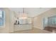 Bright dining area features an island with bar stool seating that adjoins the kitchen area with lots of natural light at 7158 Westhill Ct, Lakewood Ranch, FL 34202