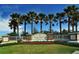 Landscaped entrance to Country Club East at Lakewood Ranch community, featuring a decorative sign and palm trees at 7158 Westhill Ct, Lakewood Ranch, FL 34202