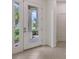 Bright entryway features a white door with glass panels and tile flooring at 7158 Westhill Ct, Lakewood Ranch, FL 34202