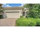 Charming home exterior featuring a brick driveway and lush landscaping at 7158 Westhill Ct, Lakewood Ranch, FL 34202