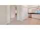 Hallway view to kitchen with white cabinetry, stainless appliances and dining area at 7158 Westhill Ct, Lakewood Ranch, FL 34202