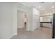 Open hallway leading to a kitchen with stainless steel appliances at 7158 Westhill Ct, Lakewood Ranch, FL 34202