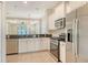 Modern kitchen with stainless steel appliances, granite countertops, and pendant lighting at 7158 Westhill Ct, Lakewood Ranch, FL 34202