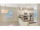 Bright, open kitchen with granite countertops, pendant lighting, stainless steel appliances, and seamless living space at 7158 Westhill Ct, Lakewood Ranch, FL 34202