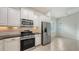 Well-lit kitchen boasts stainless steel appliances and white cabinets at 7158 Westhill Ct, Lakewood Ranch, FL 34202