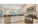 Open kitchen with granite countertops and stainless steel appliances overlooking the living area at 7158 Westhill Ct, Lakewood Ranch, FL 34202