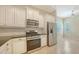 Bright kitchen featuring white cabinets, stainless steel appliances, and a tiled backsplash at 7158 Westhill Ct, Lakewood Ranch, FL 34202