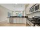 Modern kitchen with granite countertops, stainless steel appliances, and white cabinetry at 7158 Westhill Ct, Lakewood Ranch, FL 34202