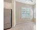 Bright kitchen nook with tiled floor, stainless steel fridge, and natural light from shuttered windows at 7158 Westhill Ct, Lakewood Ranch, FL 34202