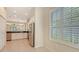 Eat-in kitchen with white cabinetry and stainless appliances, and natural light from shuttered windows at 7158 Westhill Ct, Lakewood Ranch, FL 34202