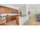 Kitchen with granite countertops, wood cabinets, stainless steel appliances, and a breakfast bar at 7158 Westhill Ct, Lakewood Ranch, FL 34202