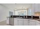 Open-concept kitchen with granite countertops, stainless steel appliances, and seamless access to living areas at 7158 Westhill Ct, Lakewood Ranch, FL 34202