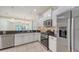 Modern kitchen featuring stainless steel appliances, granite countertops, and white cabinetry at 7158 Westhill Ct, Lakewood Ranch, FL 34202