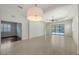 Spacious living room with tile floors and sliding glass doors to the lanai and pool area at 7158 Westhill Ct, Lakewood Ranch, FL 34202