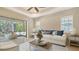 Living room featuring bright decor, ceiling fan, and open view to screened in pool at 7158 Westhill Ct, Lakewood Ranch, FL 34202
