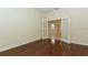 Hardwood office with modern glass french doors and a view into a living area at 7158 Westhill Ct, Lakewood Ranch, FL 34202