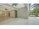 View of the covered patio with sliding glass door overlooking a screened lanai and green backyard space at 7158 Westhill Ct, Lakewood Ranch, FL 34202
