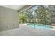 The screened-in lanai features an in-ground pool with a waterfall feature and lush landscaping at 7158 Westhill Ct, Lakewood Ranch, FL 34202