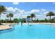 Community pool featuring splash pad area, shallow entrance, and palm tree landscaping at 7158 Westhill Ct, Lakewood Ranch, FL 34202