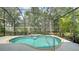 The screened-in lanai features an in-ground pool with a waterfall feature and lush landscaping at 7158 Westhill Ct, Lakewood Ranch, FL 34202