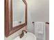 Well-lit powder bathroom with a decorative mirror, vanity and a towel rack at 7576 Plantation Cir, Bradenton, FL 34201