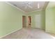 Well-lit bedroom featuring carpet, two entry doors, and a ceiling fan with a nearby bathroom at 7576 Plantation Cir, Bradenton, FL 34201