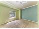 Comfortable bedroom with large window, neutral carpet, ceiling fan, and plenty of natural light at 7576 Plantation Cir, Bradenton, FL 34201