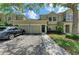 Inviting townhome featuring a two-car garage, neutral exterior, and well-maintained landscaping at 7576 Plantation Cir, Bradenton, FL 34201