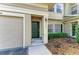Charming front door with sidelights, complemented by a well-manicured front yard at 7576 Plantation Cir, Bradenton, FL 34201