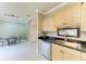 Eat-in kitchen boasts light wood cabinetry, granite counters, a breakfast nook, and stainless steel dishwasher at 7576 Plantation Cir, Bradenton, FL 34201