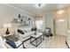 Inviting living room with modern décor, a comfortable seating arrangement, and ample lighting at 7576 Plantation Cir, Bradenton, FL 34201